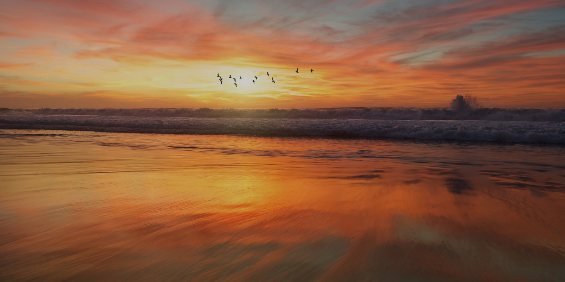 Sunrise light spreading across a calm ocean horizon